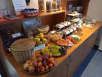 a buffet with different types of fruits and vegetables at Hotel Am Hohen Schwarm in Saalfeld