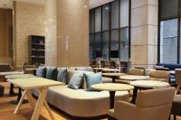 a lobby with a couch and tables and chairs at City Suites - Taipei Nandong in Taipei