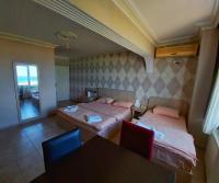 A bed or beds in a room at KILIÇ MOTEL