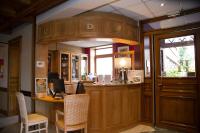 a kitchen with a bar with a table and chairs at Hotel Eden in Béthune