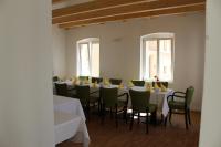 a dining room with white tables and green chairs at Gästehaus Reckahn der Rochow Akademie in Reckahn