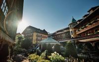 a group of buildings with a gazebo in a courtyard at Hotel Pichlmayrgut in Schladming