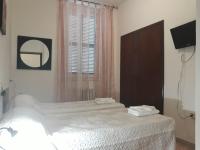 a bedroom with a bed with a mirror and a window at Hotel La Torretta in Foligno