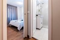 Łóżko lub łóżka w pokoju w obiekcie Nel Centro City Apartment