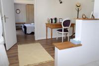 a living room with a table and a desk at Les Bessonnes in Saint-Georges-Haute-Ville