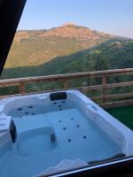 a jacuzzi tub on a balcony with a view of a mountain at Villa Kalaja in Novoberdo