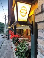 a light on the side of a restaurant with red flowers at Apartman Poirot in Érd