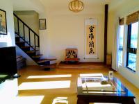 a living room with stairs and a glass table at Celine&#39;s B&amp;B in Fenglin