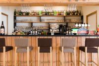 a bar with four chairs in front of it at Village Vacances le Bérouze in Samoëns