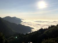 a view of a valley of clouds in the mountains at Tianyi Homestay in Fenqihu