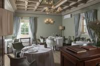 a dining room with tables and chairs and a ceiling at Villa Cordevigo in Cavaion Veronese