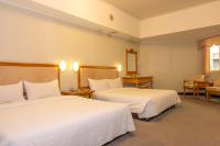 a hotel room with two beds at Kenting City Gate Hotel in Hengchun South Gate