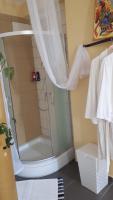 a shower with a glass door in a bathroom at Apartman studio in Vela Luka
