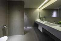 a bathroom with a shower and a sink and a toilet at Just Sleep Kaohsiung Zhongzheng in Kaohsiung