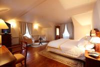 a bedroom with a bed and a table and chairs at PortoBay Serra Golf in Santo António da Serra