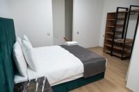 A bed or beds in a room at INN HOUSE LOFT SPA