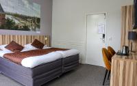 Hotel Asterisk, a family run hotelにあるベッド