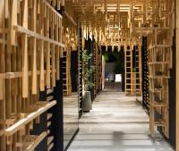 a hallway of wine racks with chandeliers at FR Hotel in Ibagué