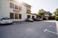 a parking lot with cars parked in front of a building at Village Vacances le Bérouze in Samoëns