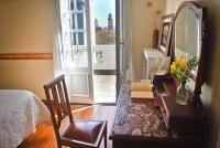 a room with a table and a mirror and a bed at Hotel Palacio in Montevideo