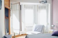 A bed or beds in a room at Balenax Pensión
