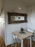 a table and chairs in a small room with a window at la cabane vensac ocean montalivet in Vensac