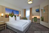 Ein Bett oder Betten in einem Zimmer der Unterkunft DORMERO Moselhotel Koblenz-Alken