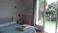 a bedroom with a bed and a large window at chez sylvette in Quinsac