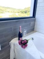 a bottle of wine and a bouquet of flowers on a table at Kenting Sunhow Inn in Kenting