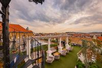 a balcony with chairs and a view of a city at Mystery Hotel Budapest in Budapest