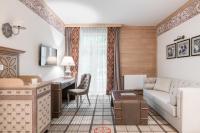 a living room with a couch and a desk at Aries Hotel & SPA Wisła in Wisła