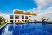 a villa with a swimming pool in front of a house at Sheng Tu Villa in Hengchun South Gate