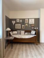 a bedroom with a bed with a wall with pictures at Au P’Tit Cosy in Bazincourt-sur-Saulx