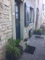 a house with a blue door and some plants at Au P’Tit Cosy in Bazincourt-sur-Saulx