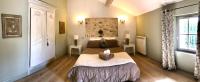 a bedroom with a large bed with two tables and a window at La Bri...Gite in L&#39;Isle-sur-la-Sorgue
