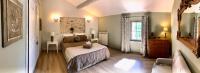 a bedroom with a bed and a couch and a window at La Bri...Gite in L&#39;Isle-sur-la-Sorgue