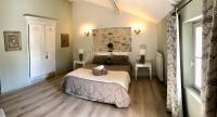 a bedroom with a bed and two tables and a window at La Bri...Gite in L&#39;Isle-sur-la-Sorgue