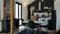 a kitchen with a table and chairs in a room at Champagne Studio in Épernay