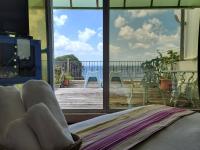 a room with a bed and a view of a deck at Ming Jun Homestay in Eluan