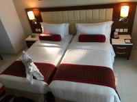 two beds in a hotel room next to each other at Treppan Hotel & Suites By Fakhruddin in Dubai