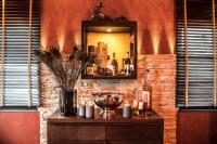 a table with a mirror on a brick wall at Mair Am Ort Living Hotel B&B in Parcines