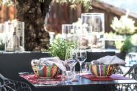 a table with two bowls and wine glasses on it at Mair Am Ort Living Hotel B&B in Parcines