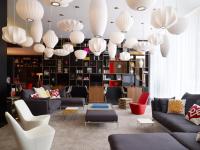 a lobby with couches and chairs and chandeliers at citizenM Southwark Bankside in London