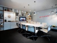 an office with a conference room with a table and chairs at citizenM Southwark Bankside in London