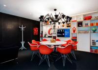 a dining room with a table and red chairs at citizenM Southwark Bankside in London
