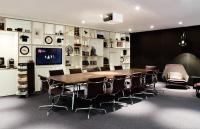 a conference room with a wooden table and chairs at citizenM Southwark Bankside in London
