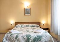 A bed or beds in a room at Argentiere Room Apartments
