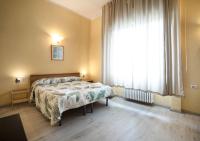 A bed or beds in a room at Argentiere Room Apartments
