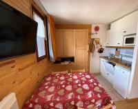a small kitchen with a red bed in a room at Boost Your Immo Les Airelles Risoul 375 in Risoul