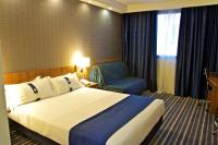 a hotel room with a bed and a chair at Holiday Inn Express Campo de Gibraltar-Barrios, an IHG Hotel in Los Barrios